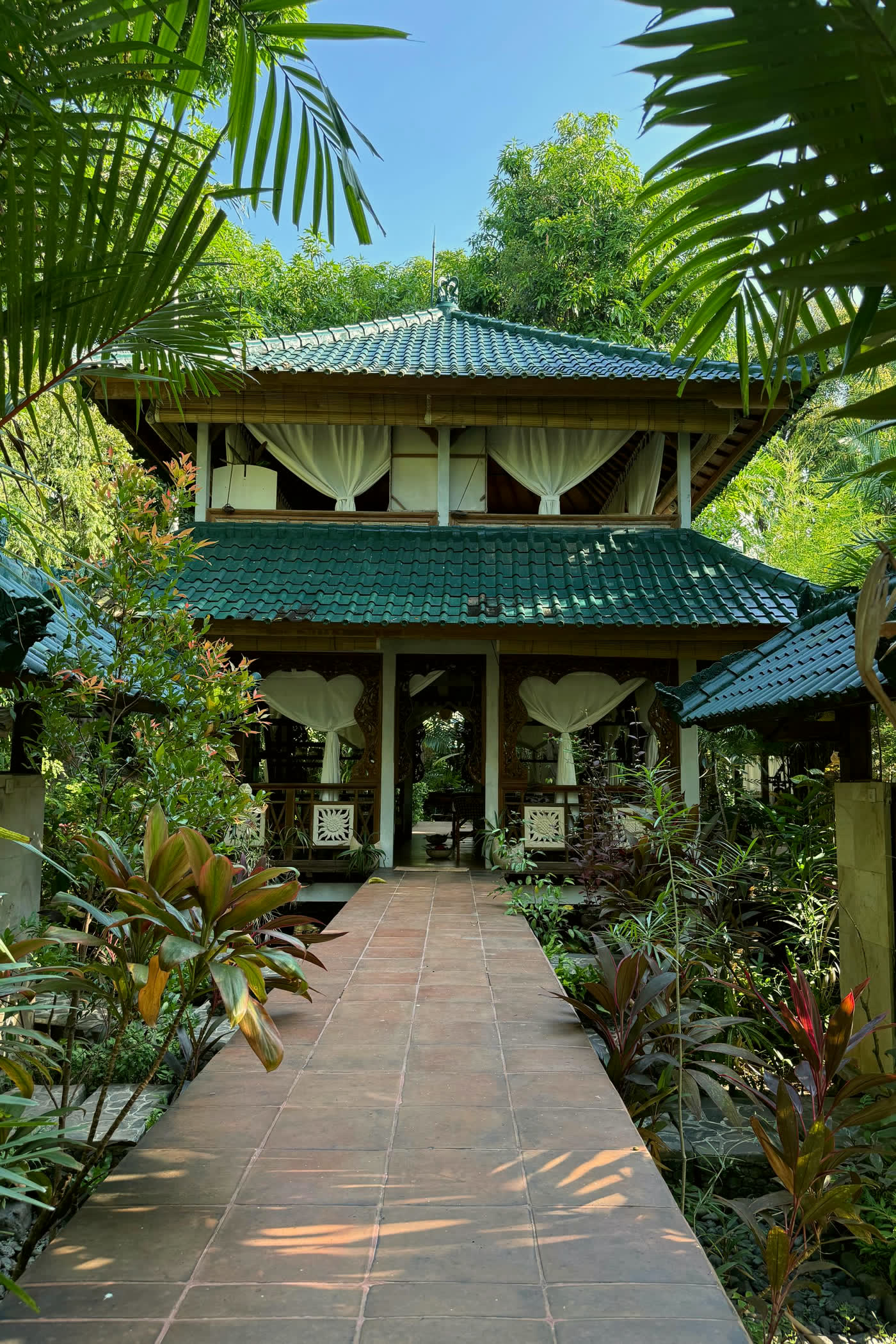 Balinese villa pavilion at the end of a planted stone path