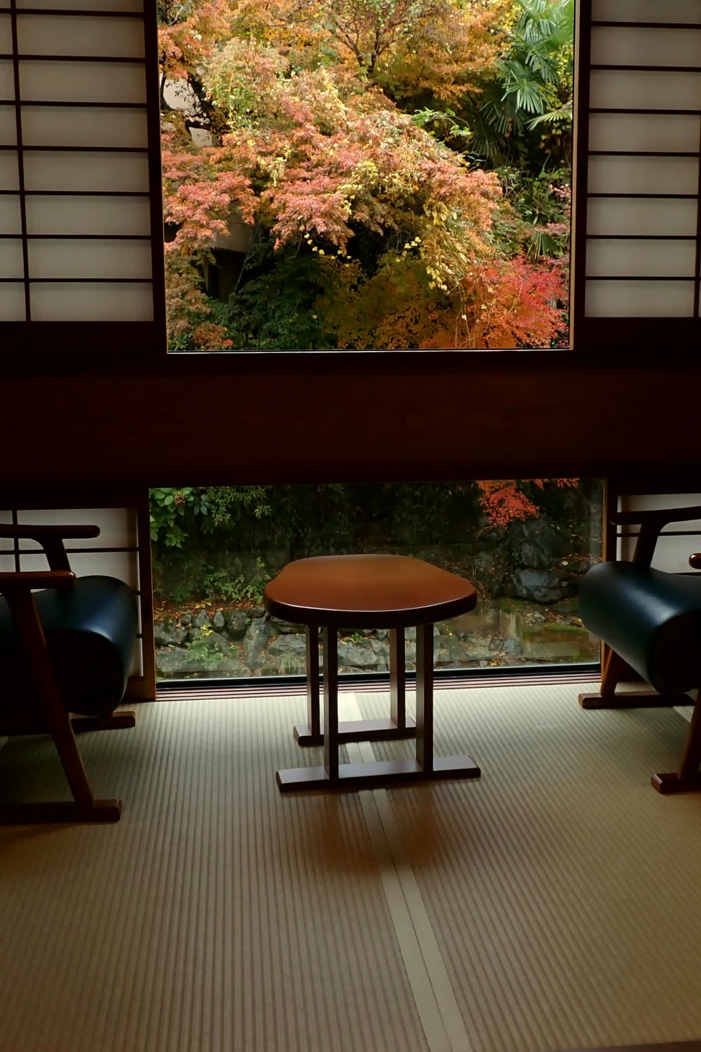 Tatami room looking onto a maple garden through a timber window