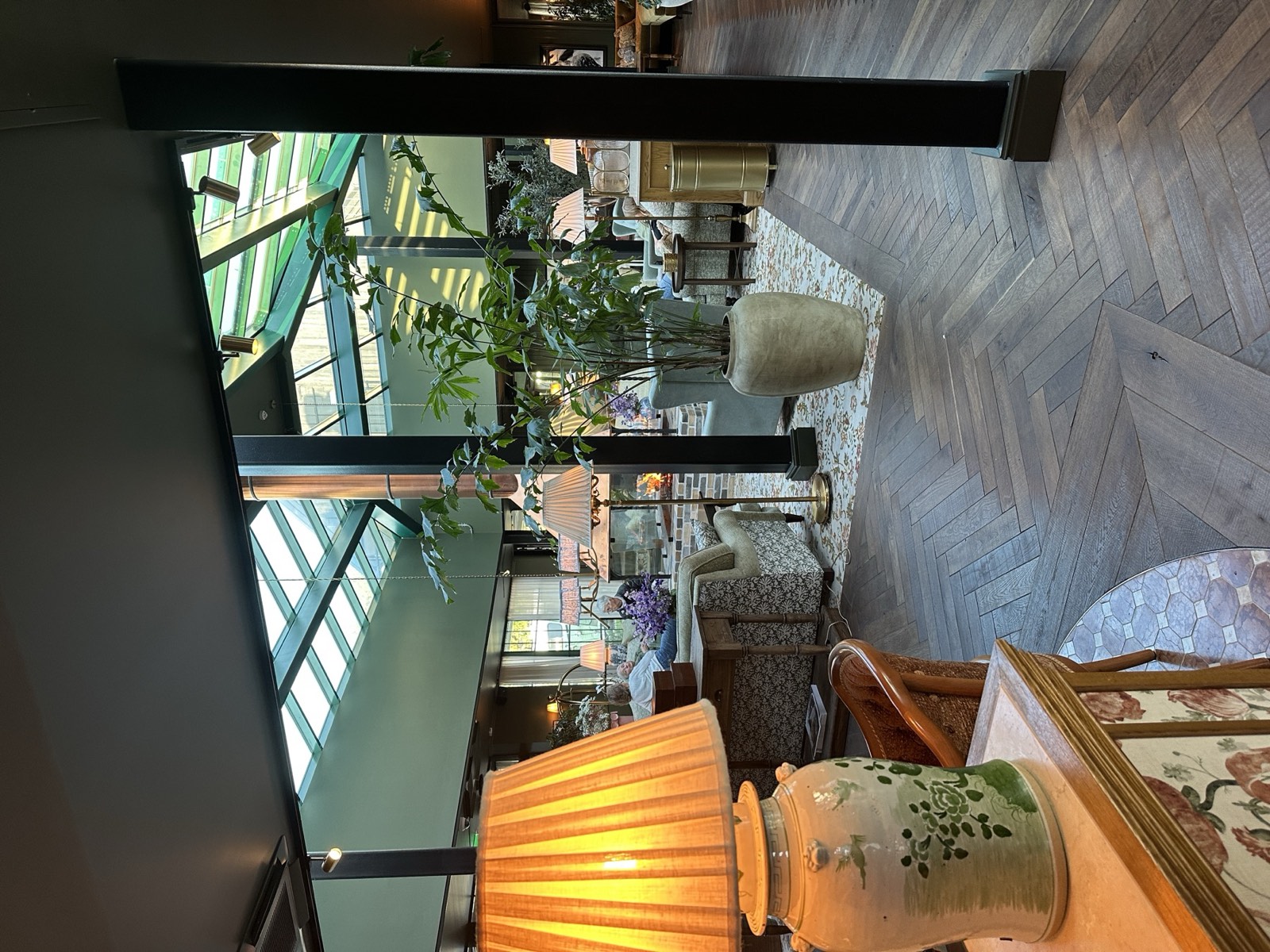 Hotel lounge with lamps, plants and a glass roof