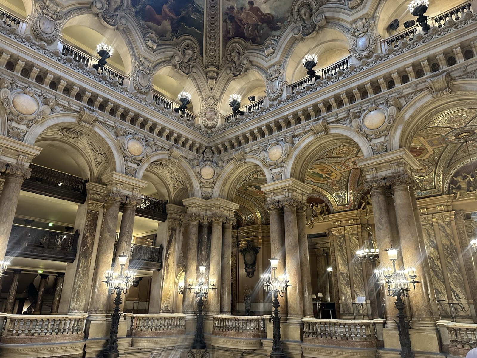 Gilded ceiling and marble columns of an ornate grand hall